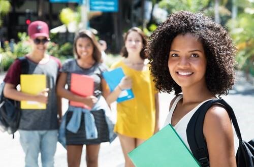 Girl holding a notebook and smiling